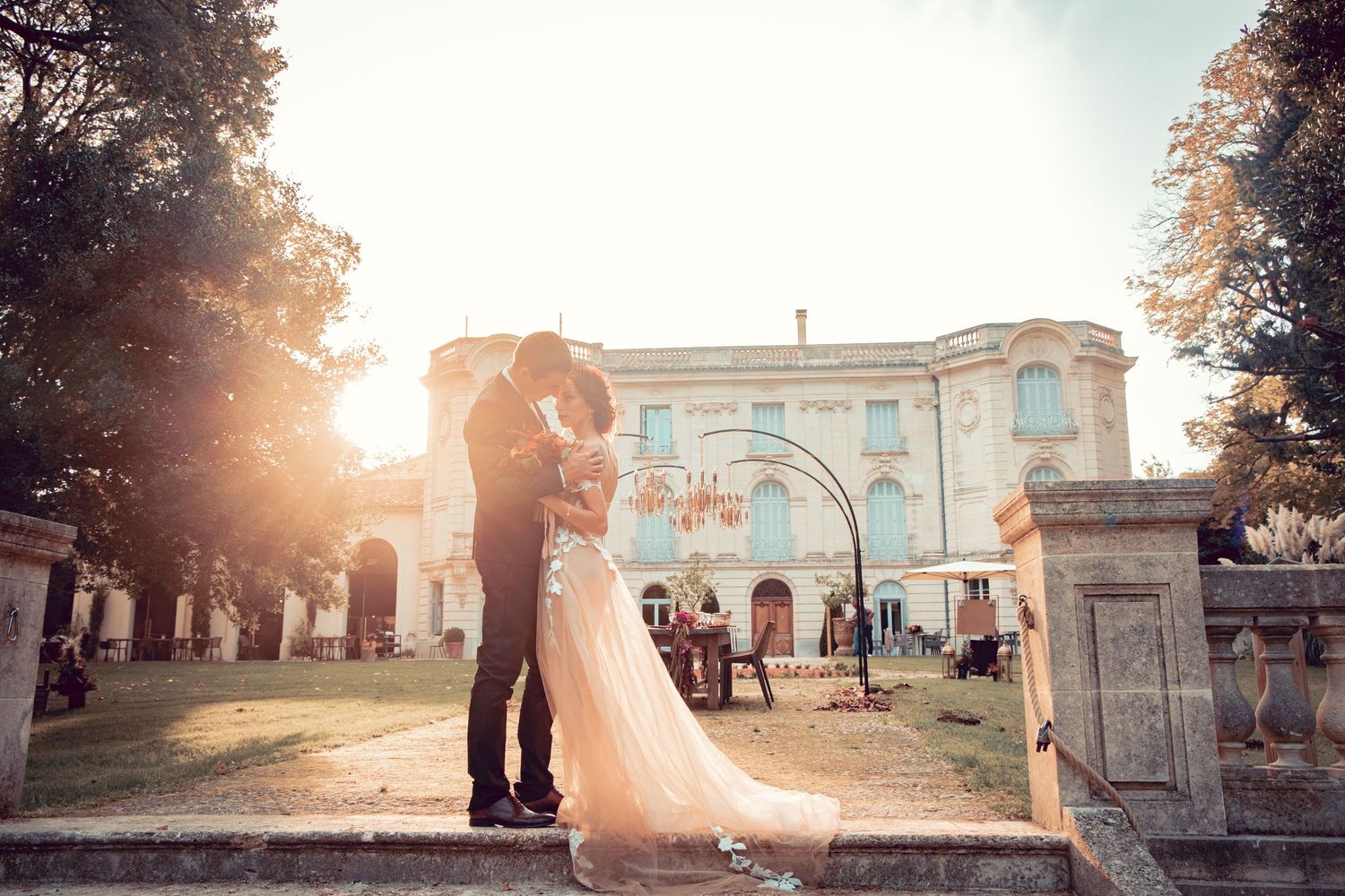 Sunset wedding portraits with golden light streaming through classical architecture.