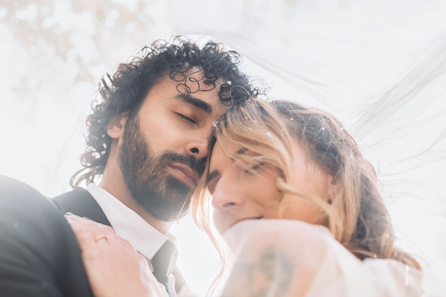 Ethereal close-up wedding portraits with dreamy backlit effect.