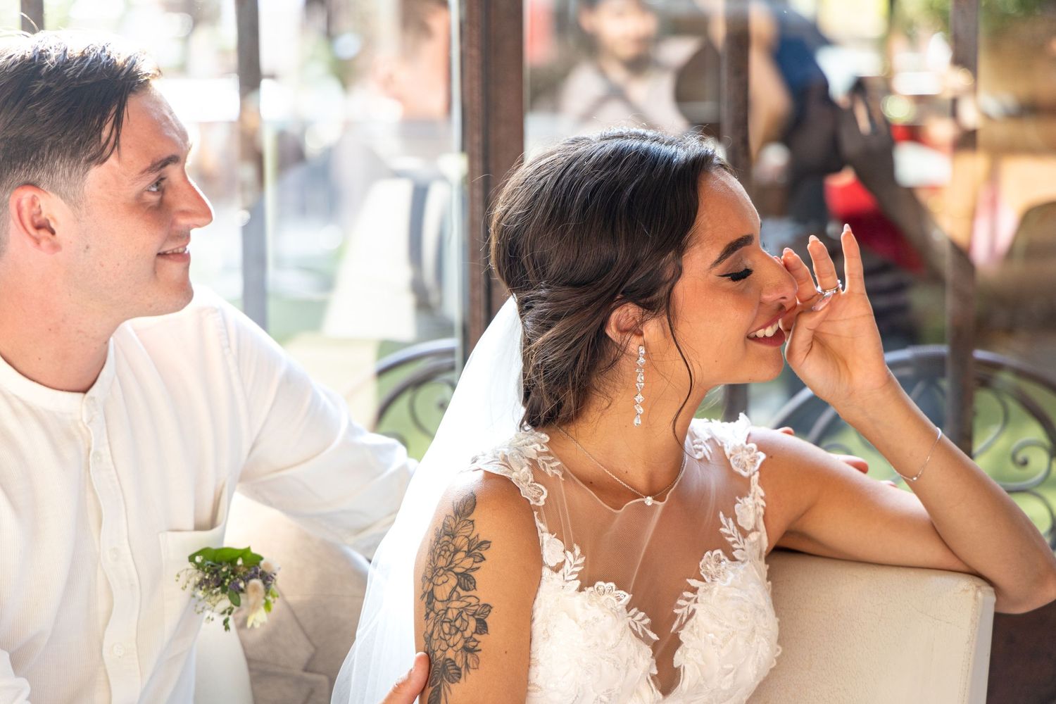 Natural light streams through windows during indoor wedding festivities.