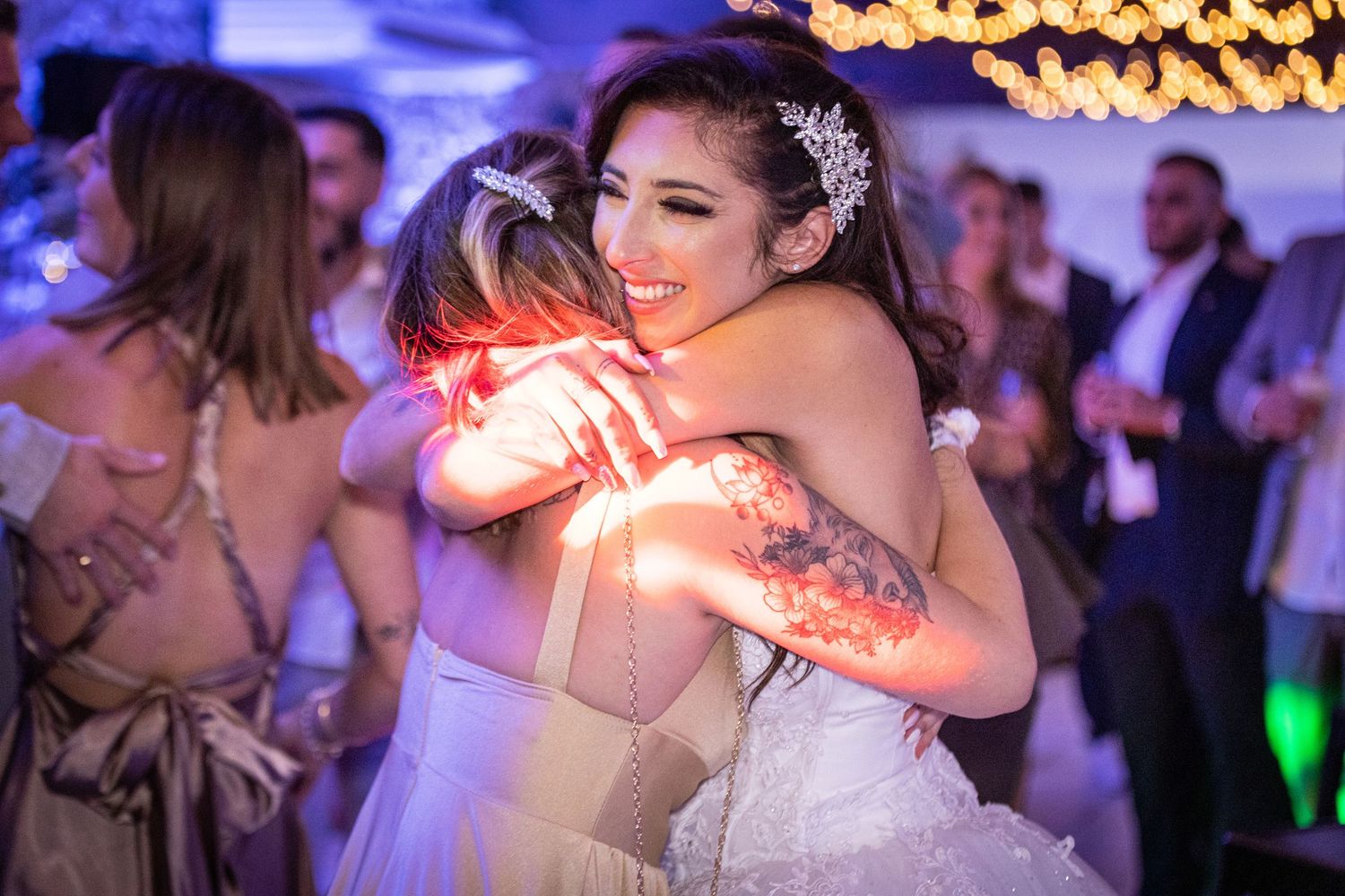 Wedding celebration featuring romantic dancing under purple and blue mood lighting.