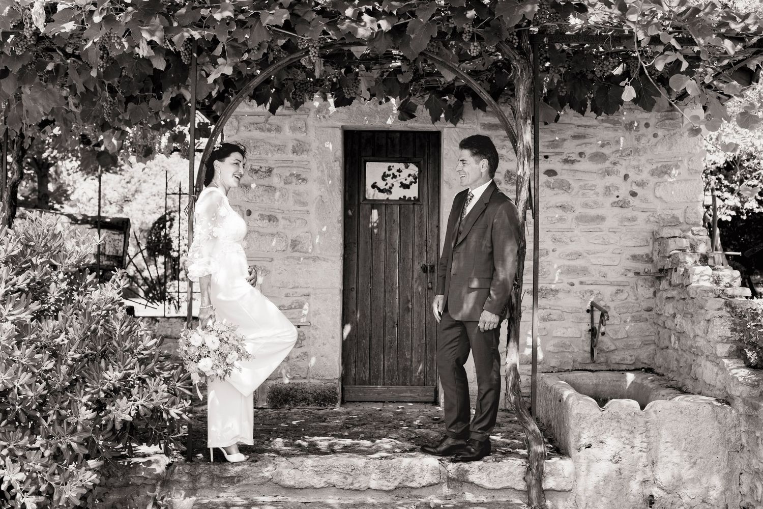 Series of romantic wedding poses against a rustic stone building backdrop.