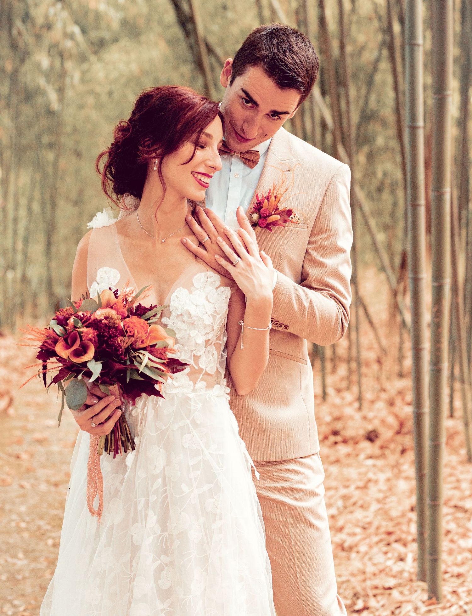 Romantic wedding portraits with burgundy flowers in a bamboo grove.