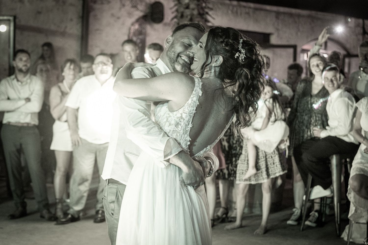 Wedding guests dance and celebrate during evening reception.