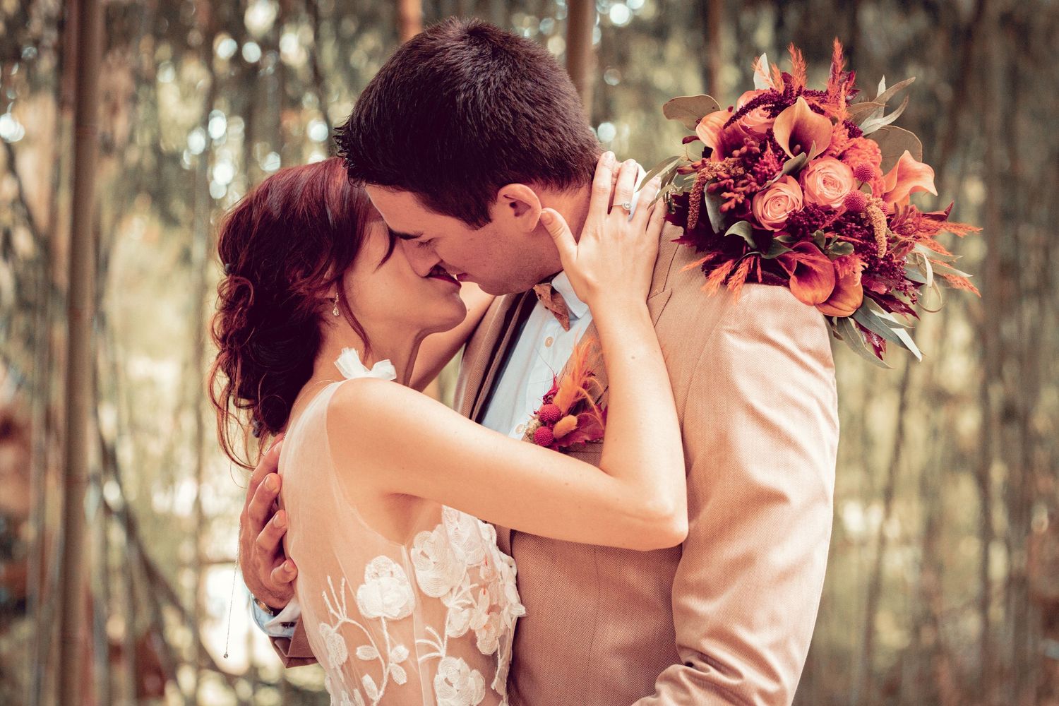 Intimate wedding moments captured among tall bamboo trees.