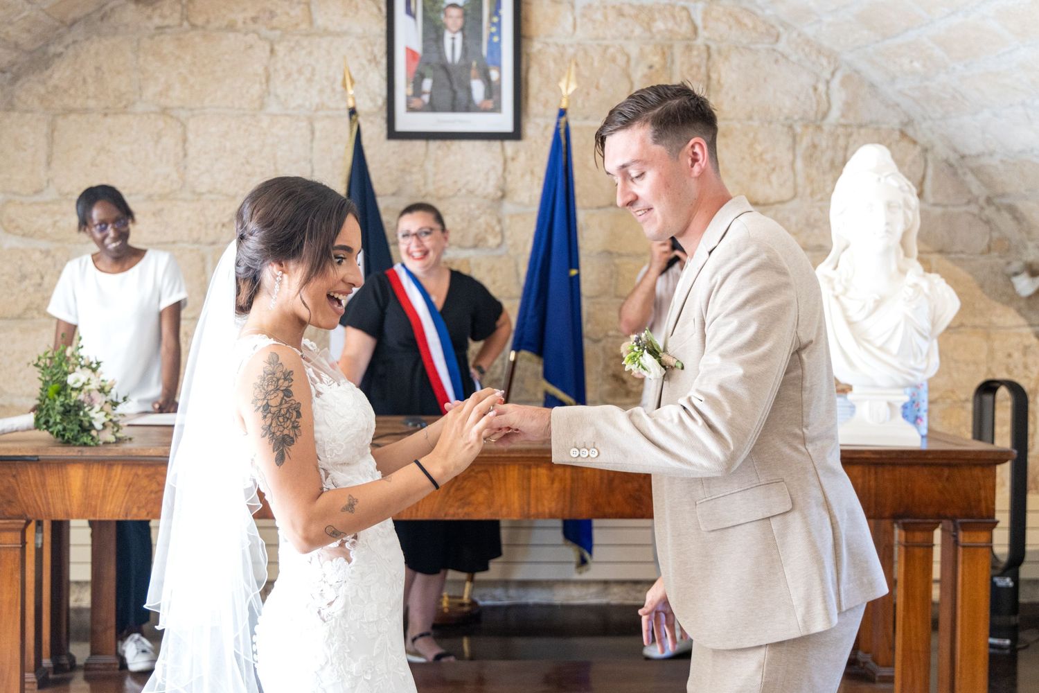 Newlyweds complete marriage paperwork at a formal signing ceremony.