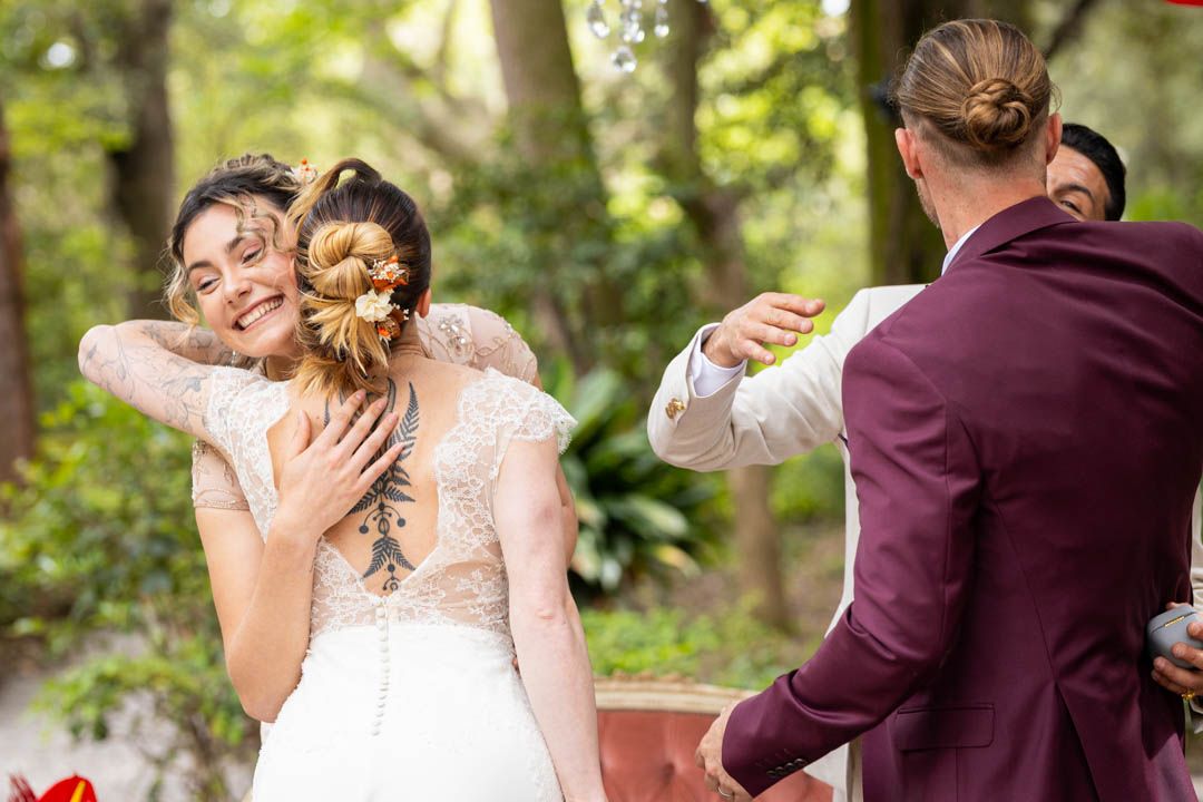 Wedding couple shares intimate moment while dancing in garden setting.