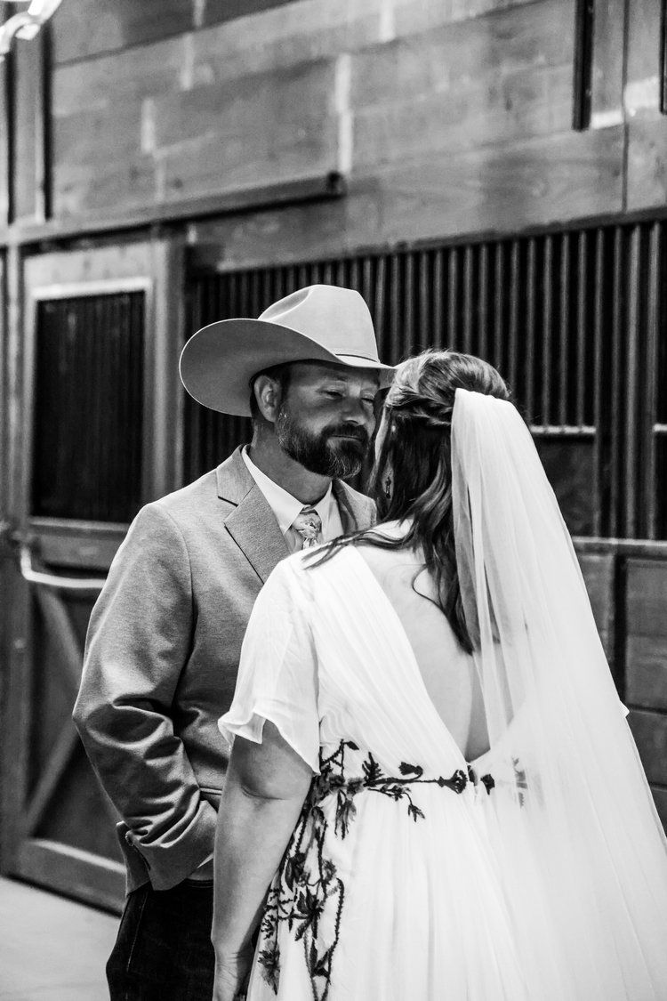 A romantic black and white wedding portrait in a rustic barn setting in Abilene, Texas.