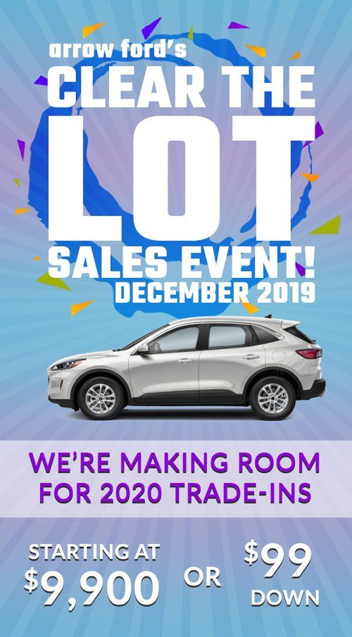 Car dealership advertisement for Clear the Lot sales event showing silver SUV with blue and purple accents.