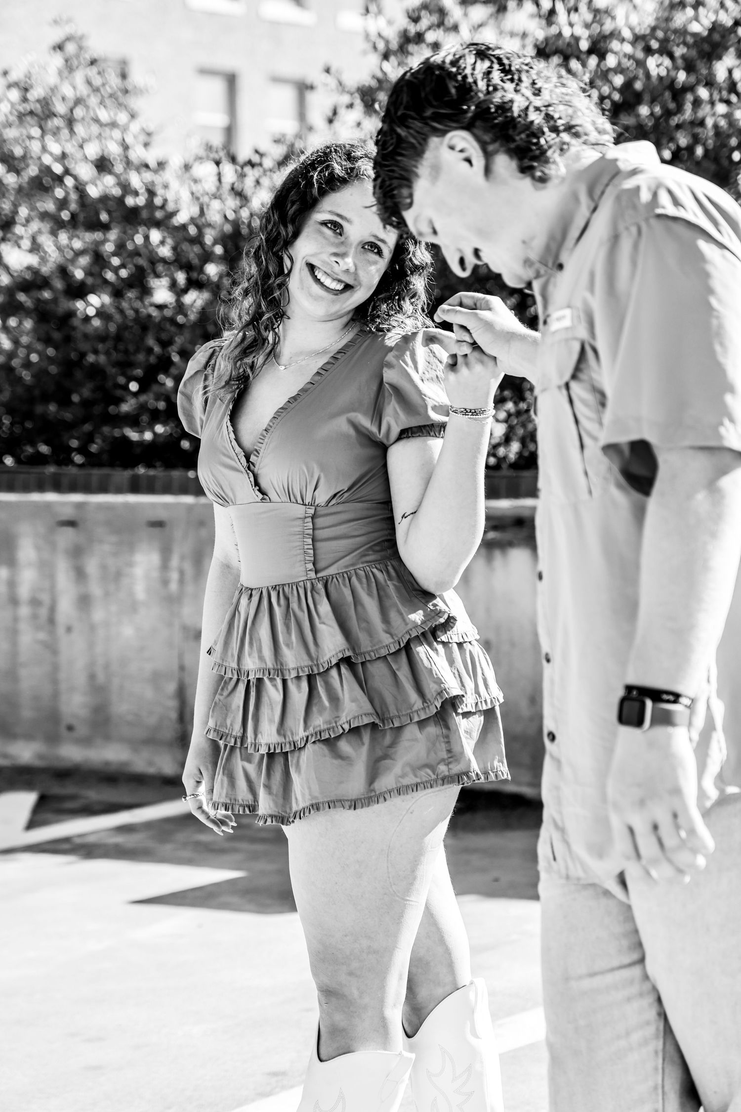 A joyful candid moment between two people in vintage-style black and white photography in Abilene, Texas.