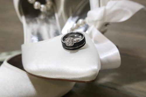 Wedding rings photographed on a white fabric with elegant styling in Abilene, Texas.