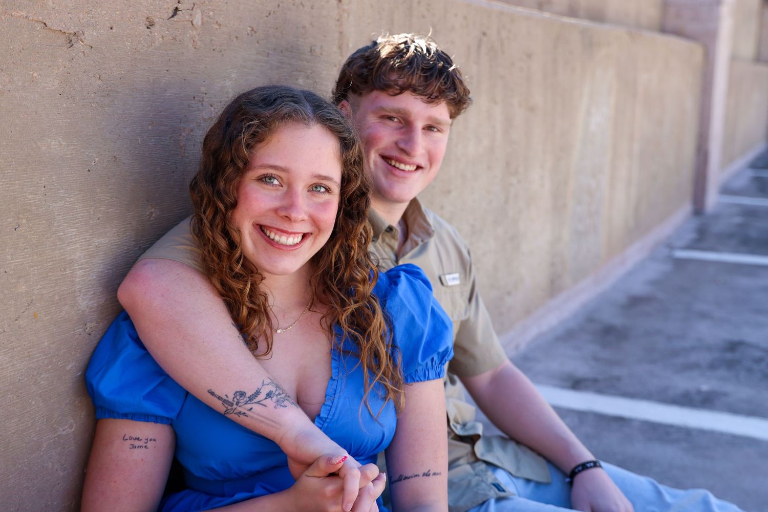 A sunny outdoor portrait of two people sitting together and sharing a happy moment in Abilene, Texas.