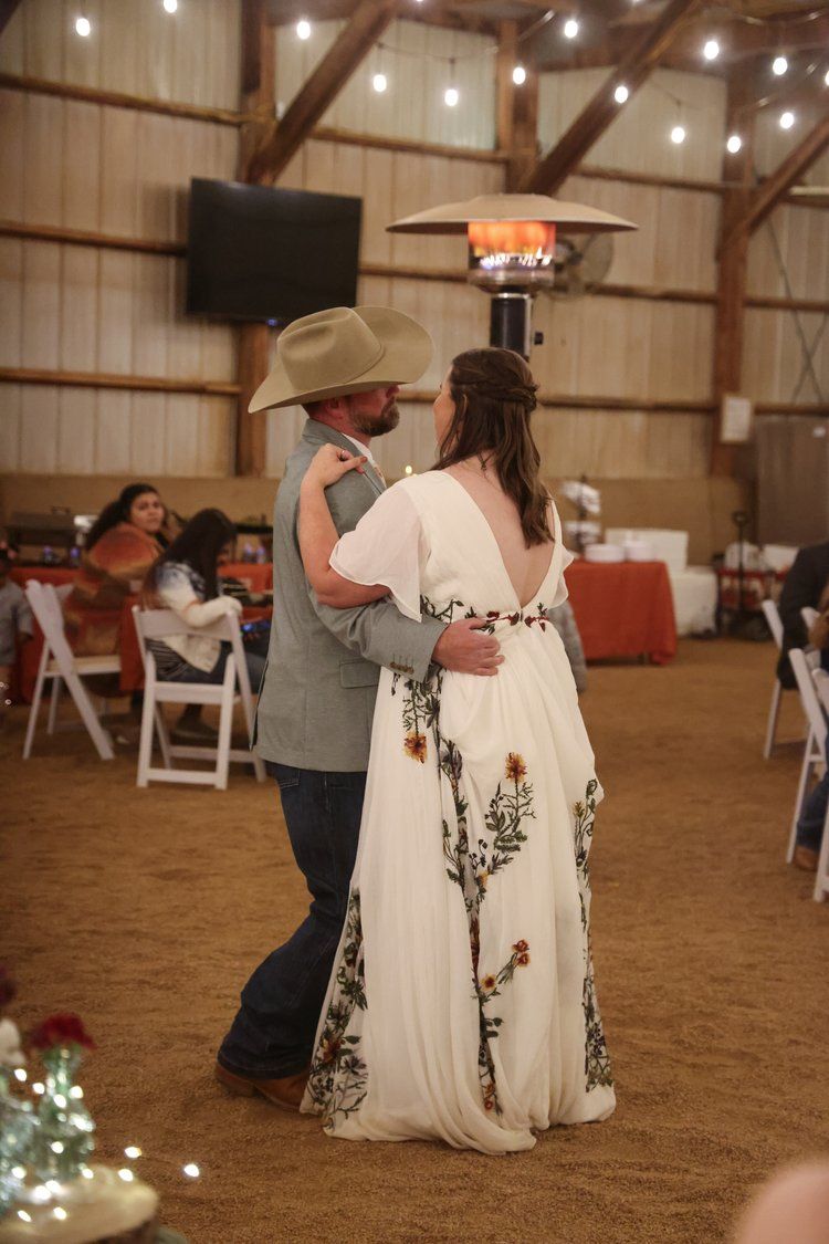 Couple sharing their first dance in a rustic barn reception venue in Abilene, Texas.