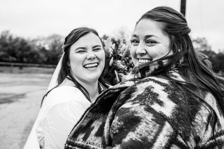 Two people sharing a joyful moment outdoors in winter wear in Abilene, Texas.