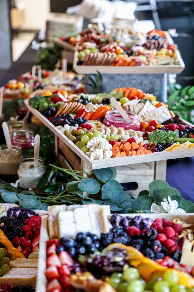 Beautifully arranged charcuterie boards with fresh fruits, vegetables, meats and cheeses displayed at a catered event in Abilene, Texas.