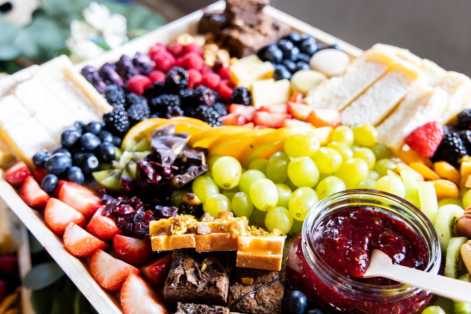 Charcuterie board with fresh fruits, cheeses, meats and jam arranged beautifully in Abilene, Texas.