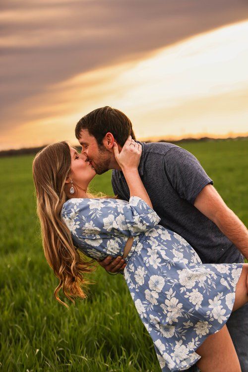 Romantic couple shares a kiss in a field during sunset in Abilene, Texas.
