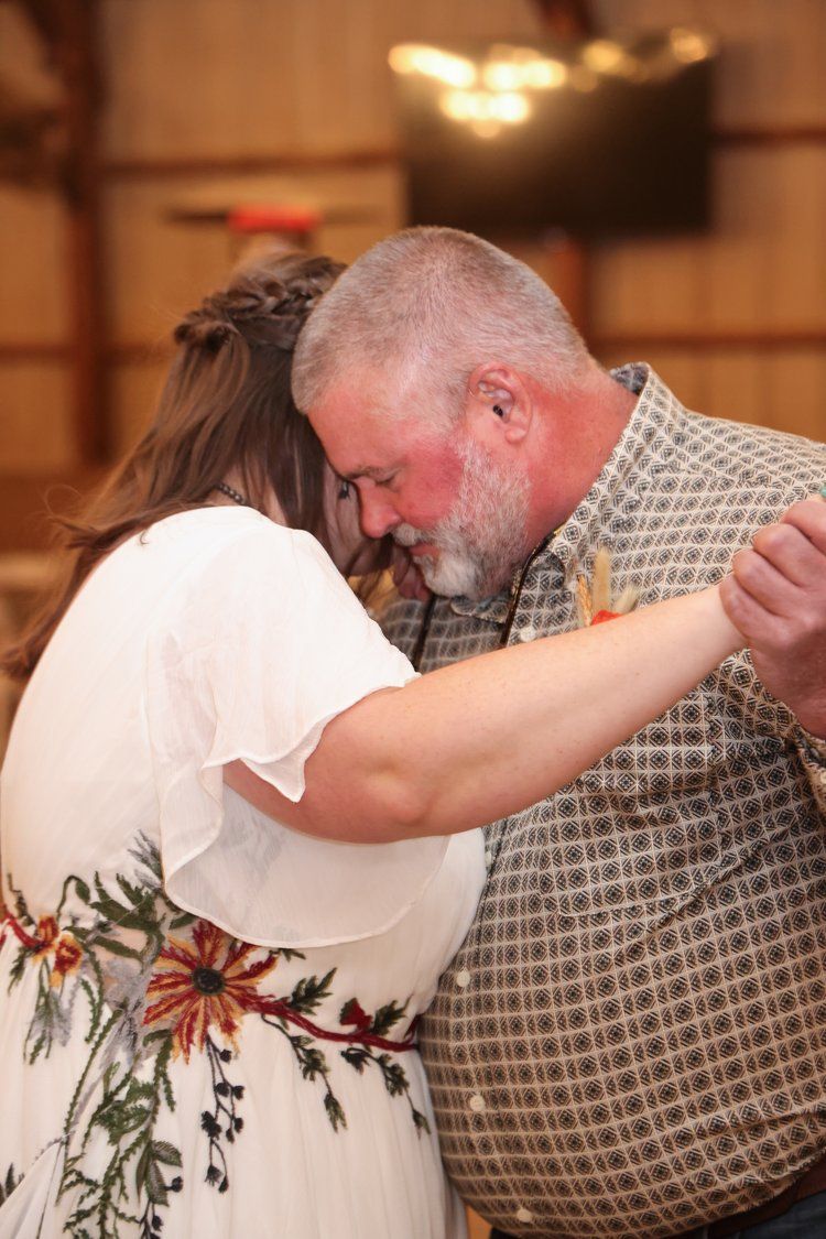An emotional father-daughter dance moment at a wedding reception in Abilene, Texas.