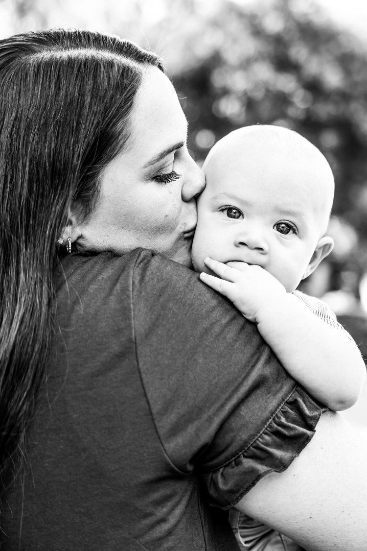 Black and white intimate moment between mother and baby outdoors in Abilene, Texas.