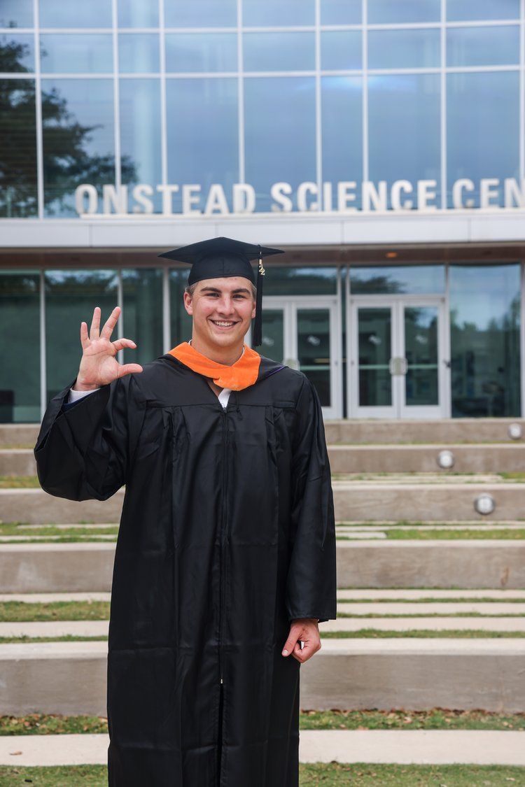 Graduate in cap and gown gives 