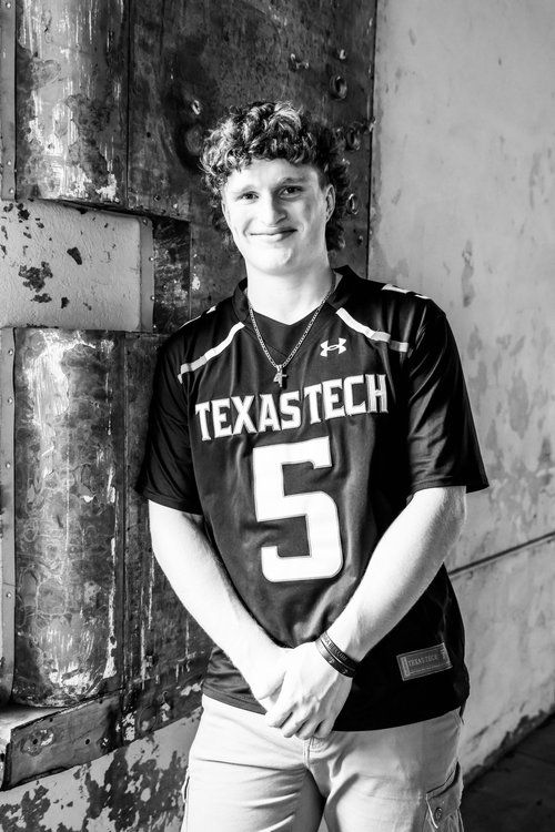 Athletic portrait featuring a Texas Tech jersey number 5 against a weathered wall background in Abilene, Texas.