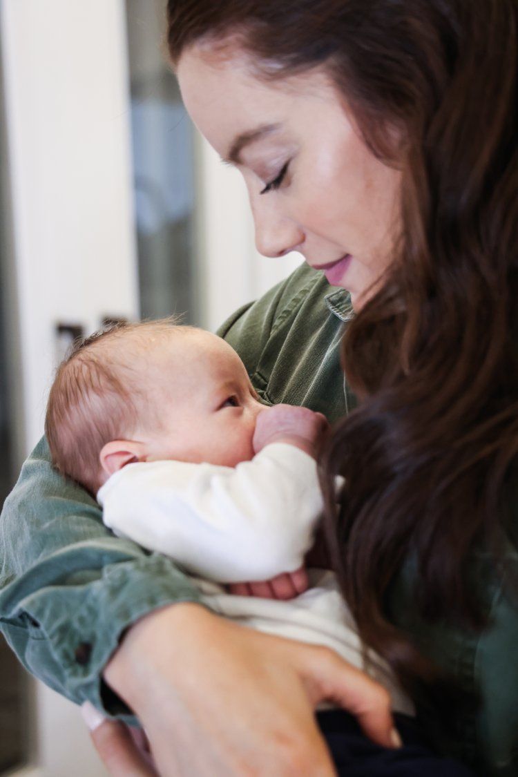Tender moment of nurturing as an infant nurses in loving arms in Abilene, Texas.