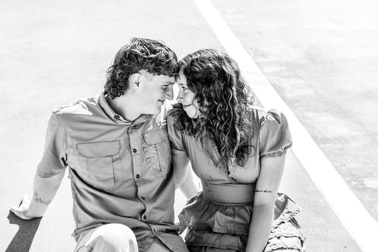 Black and white candid photo of couple sharing intimate moment outdoors in Abilene, Texas..