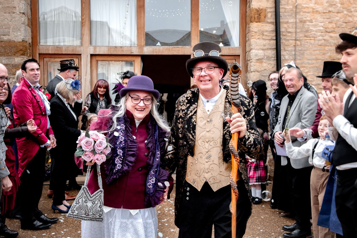 older wedding couple just married doing confetti walk. steampunk themed wedding at chester house in northamptonshire