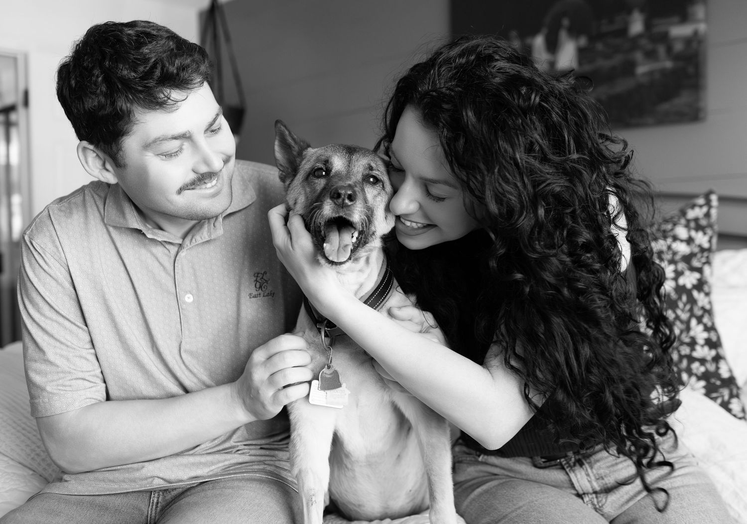 Four black and white photos showing tender moments between a couple and their playful dog.