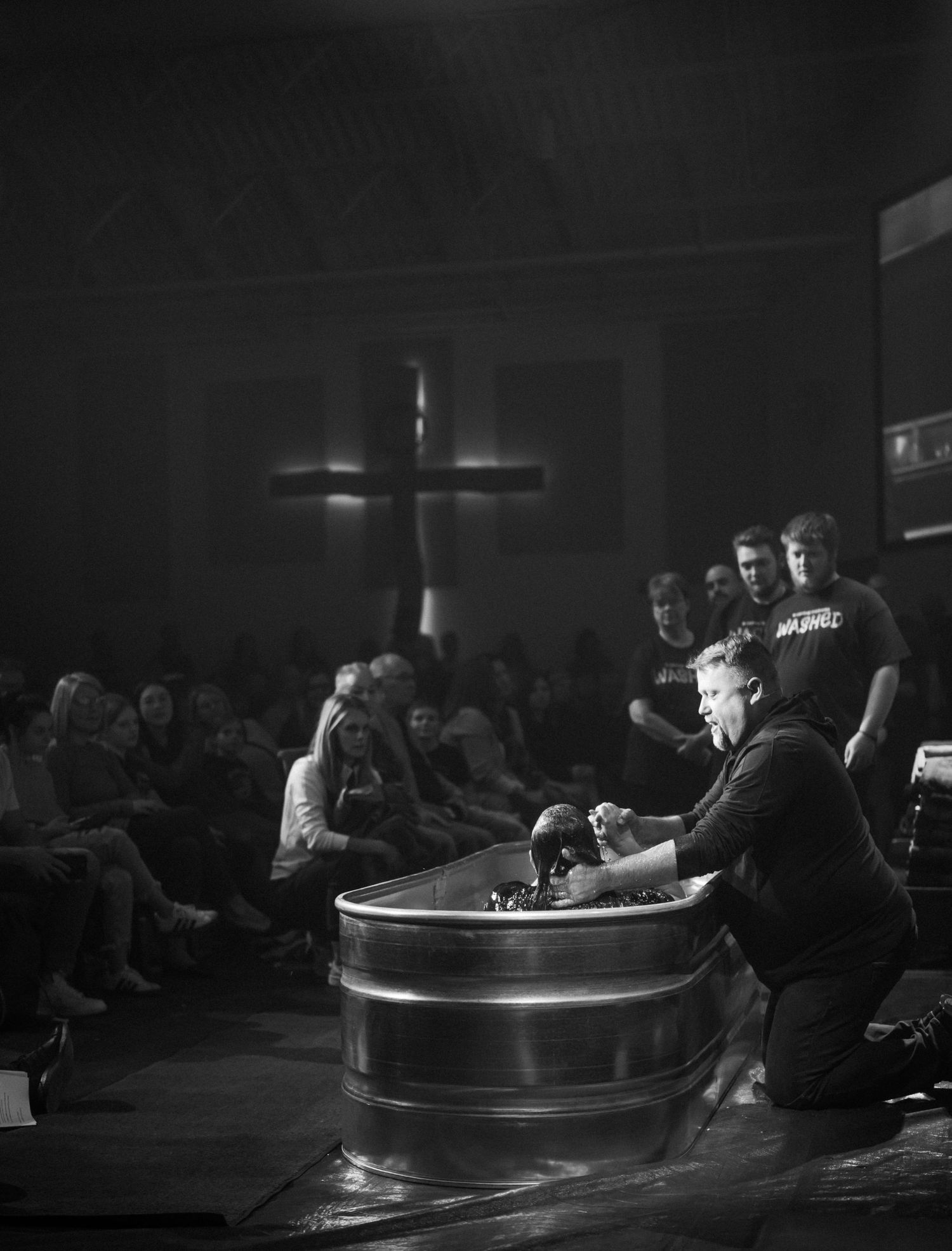 A black and white photo of a baptism service.