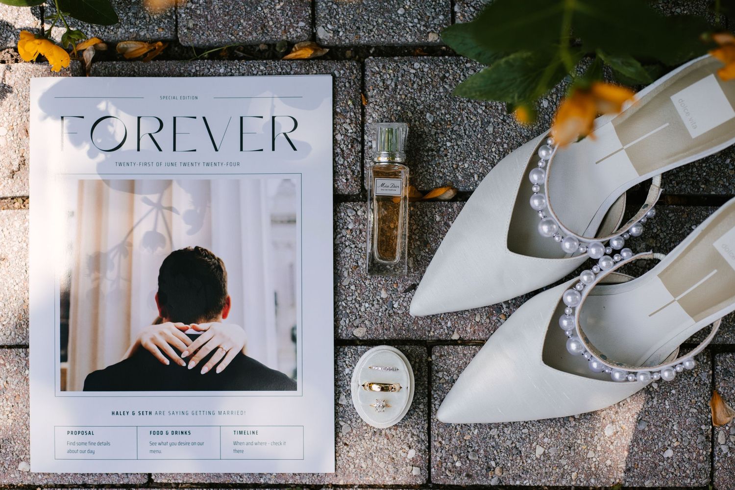 Wedding detail shots of bridal accessories including shoes and invitations on marble surface.