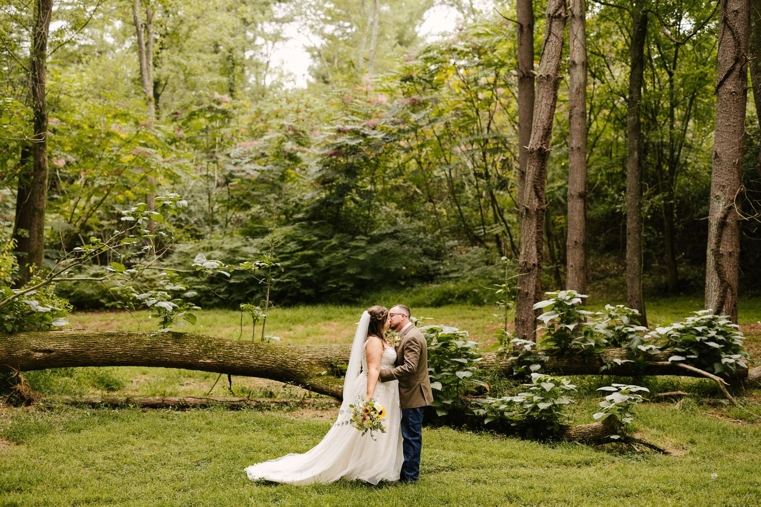 Wedding photography in a lush green garden setting with natural landscaping.
