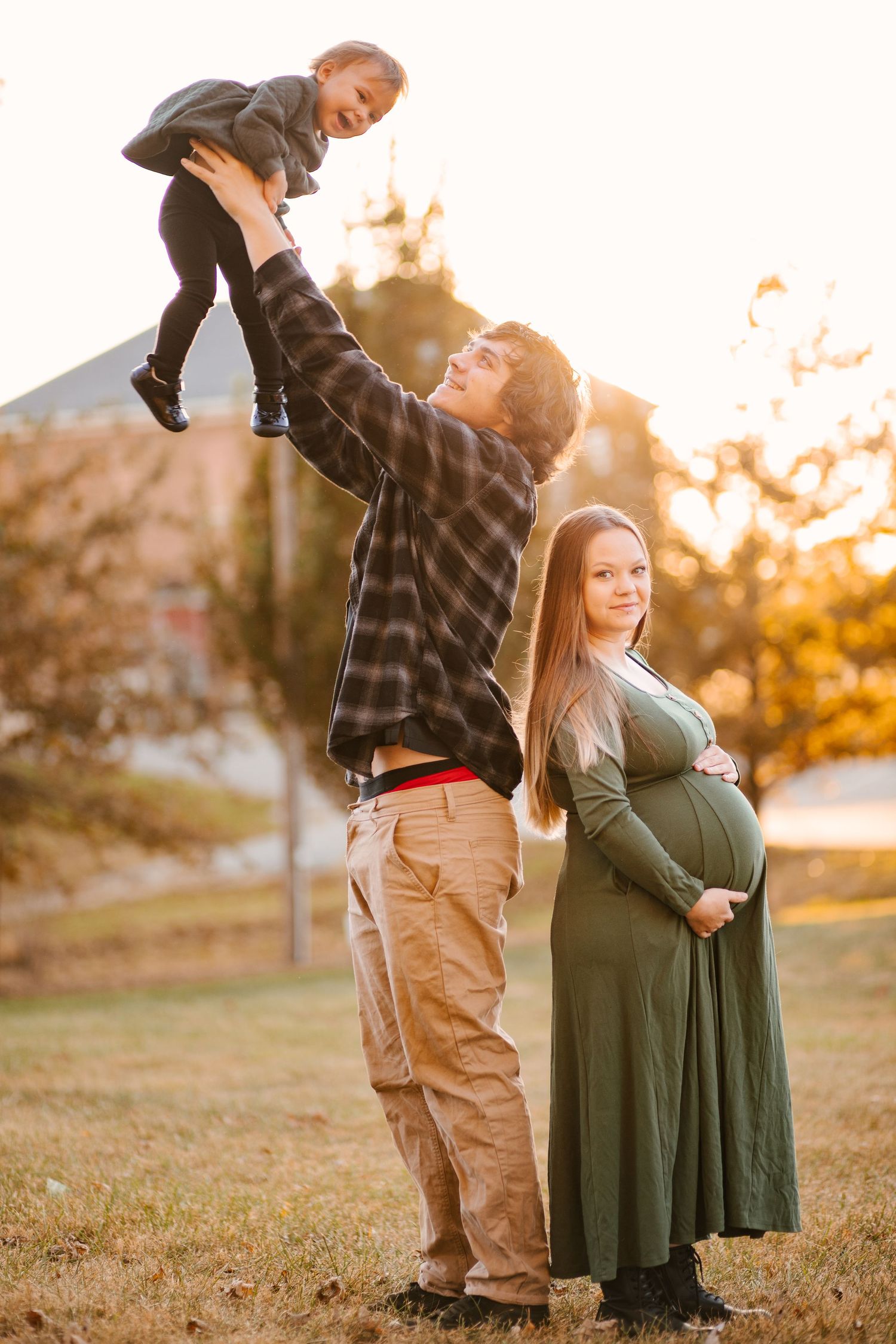 A playful sunset engagement session with the couple dancing in a grassy field.