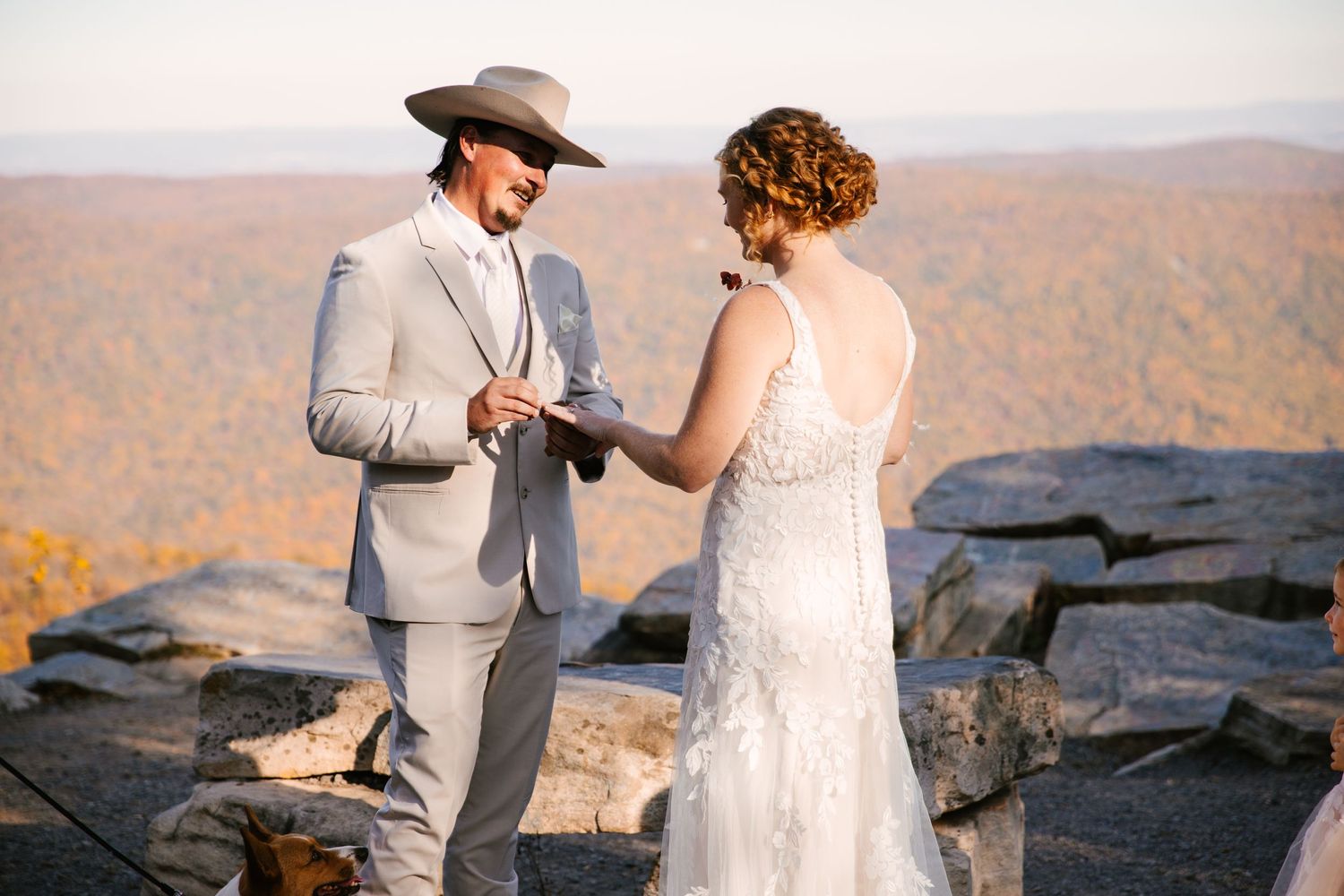 A mountain-top wedding ceremony overlooking a scenic valley landscape.