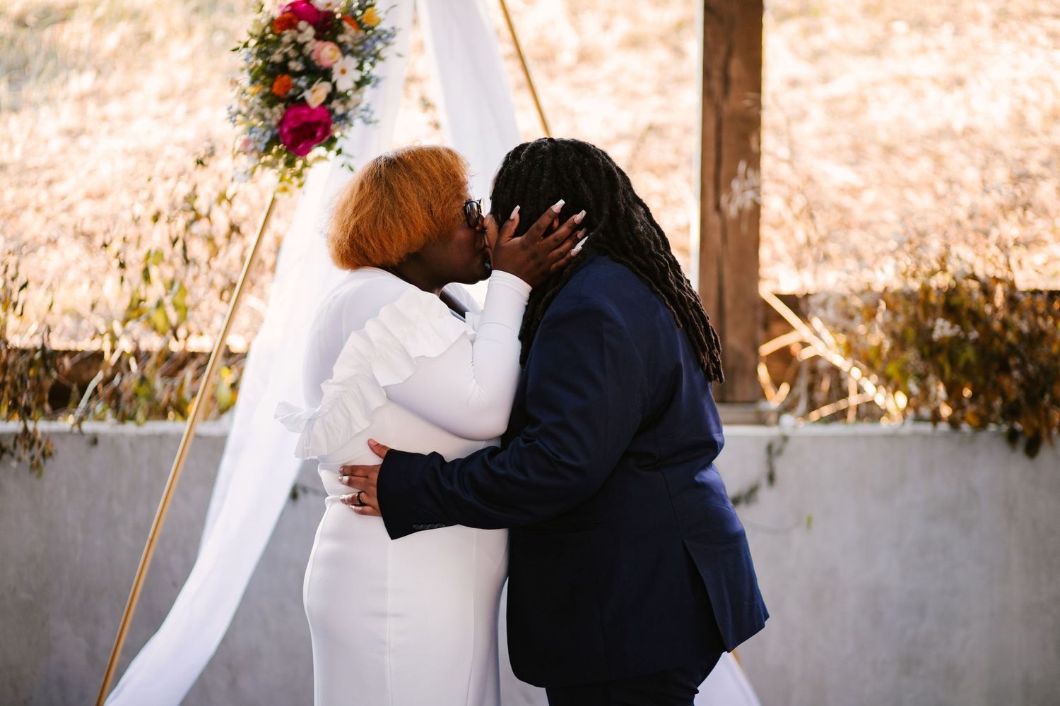 An intimate wedding ceremony moment captured in warm autumn lighting.