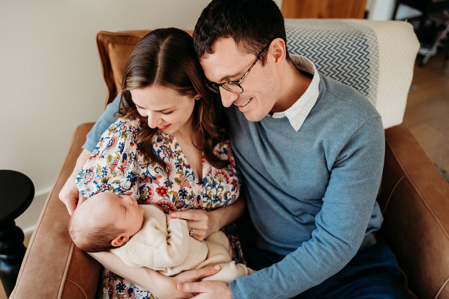 Family in loving embrace sharing tender moments together during a Westfield lifestyle newborn photography session at home.