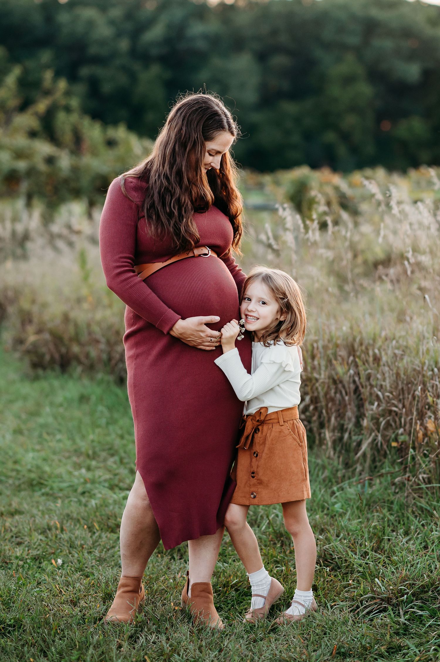 A tender moment captured in a grassy field shows a heartwarming embrace between parent and child in autumn colors at Prophetstown State Park