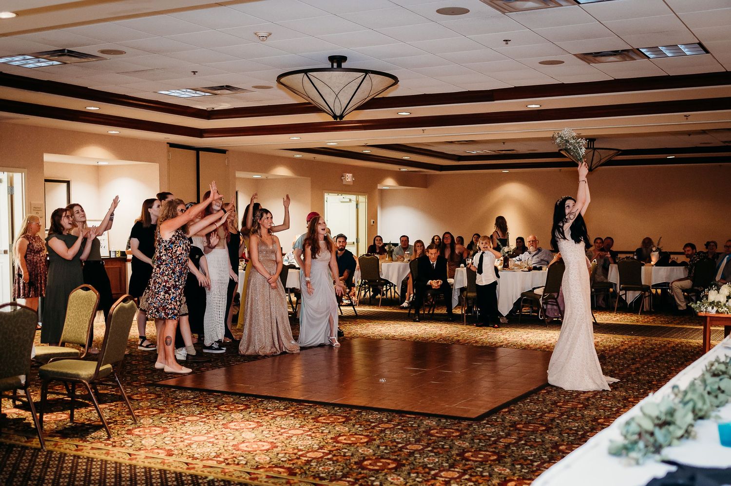 A large ballroom reception venue with elegant lighting and decorative ceiling details.