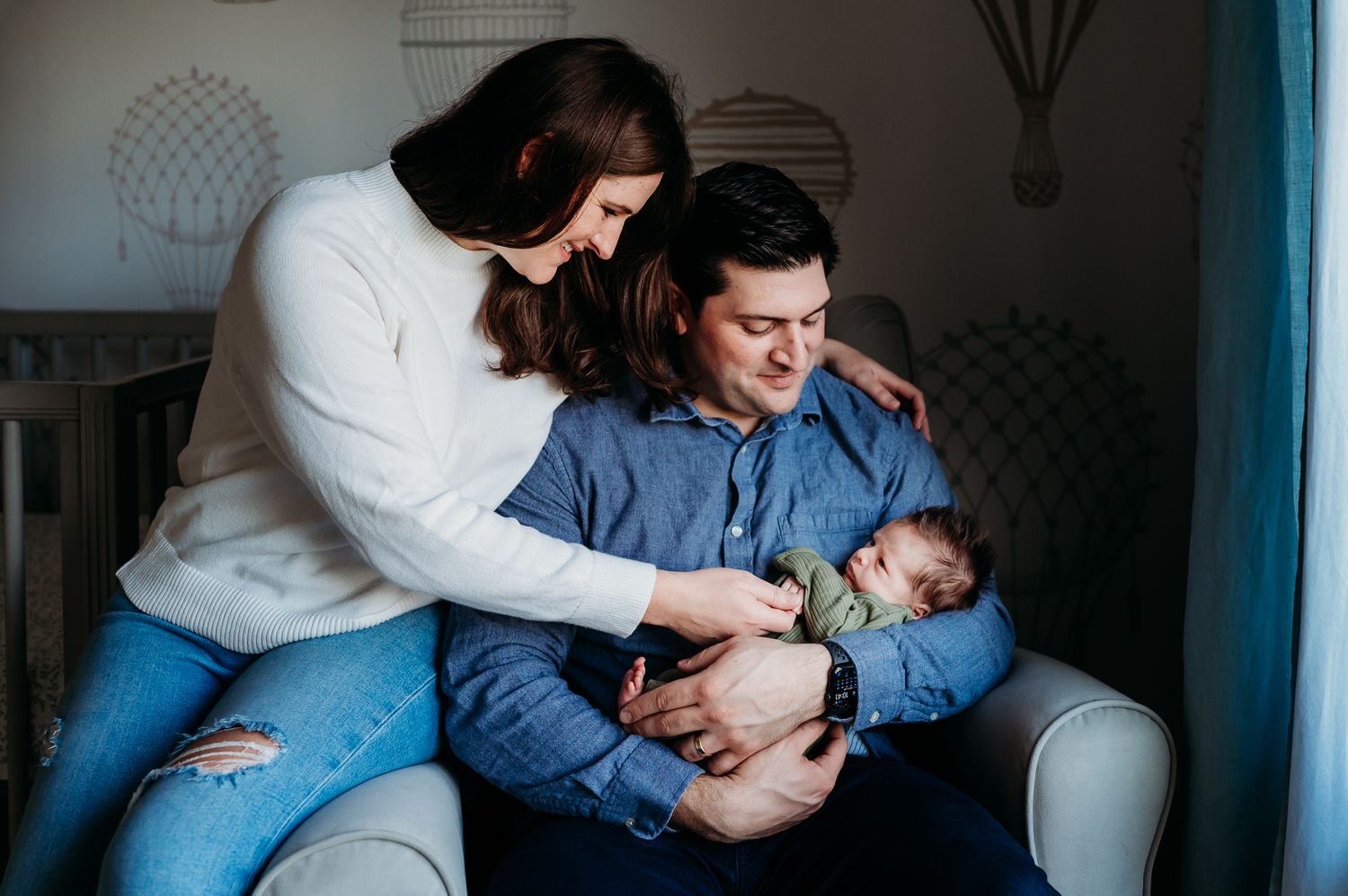 A tender sequence of photos showing intimate moments between parents and a newborn baby on a couch.