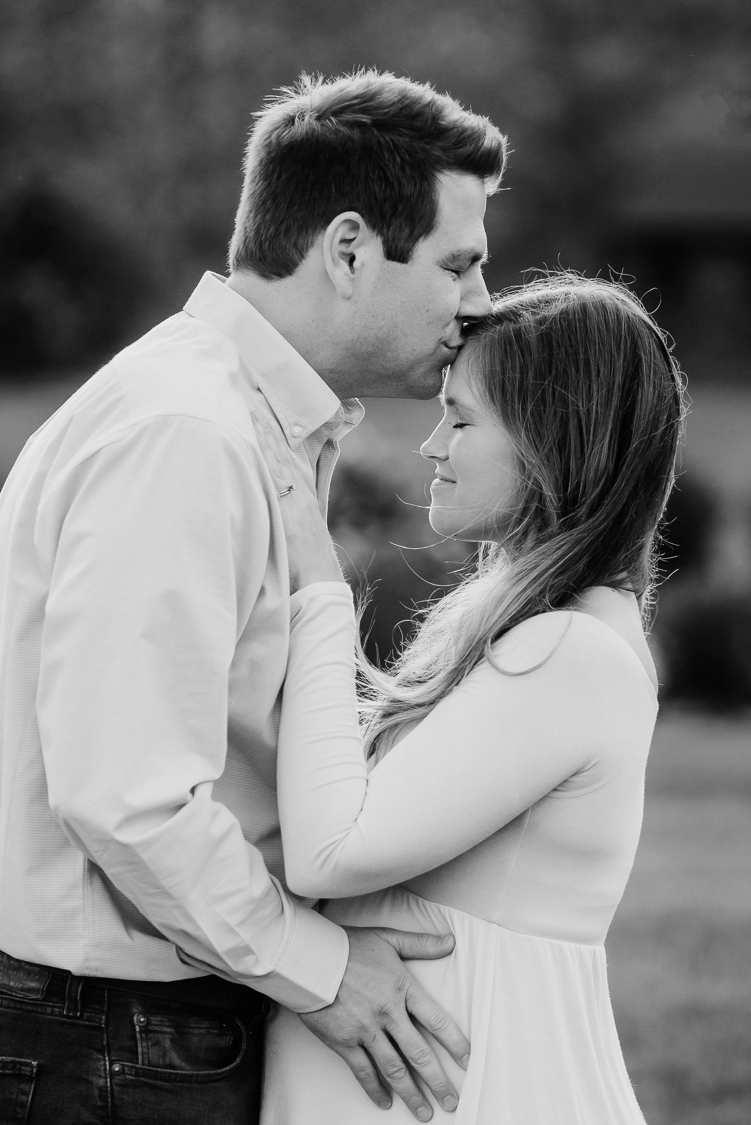 Black and white romantic portrait of a Plainfield, Indiana, couple embracing during spring maternity photo session.