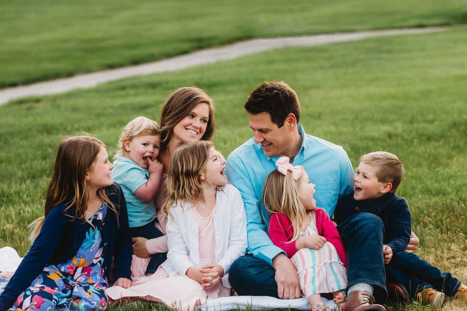 Family portrait session in Plainfield, Indiana, with parents and children wearing coordinated blue and pink outfits.