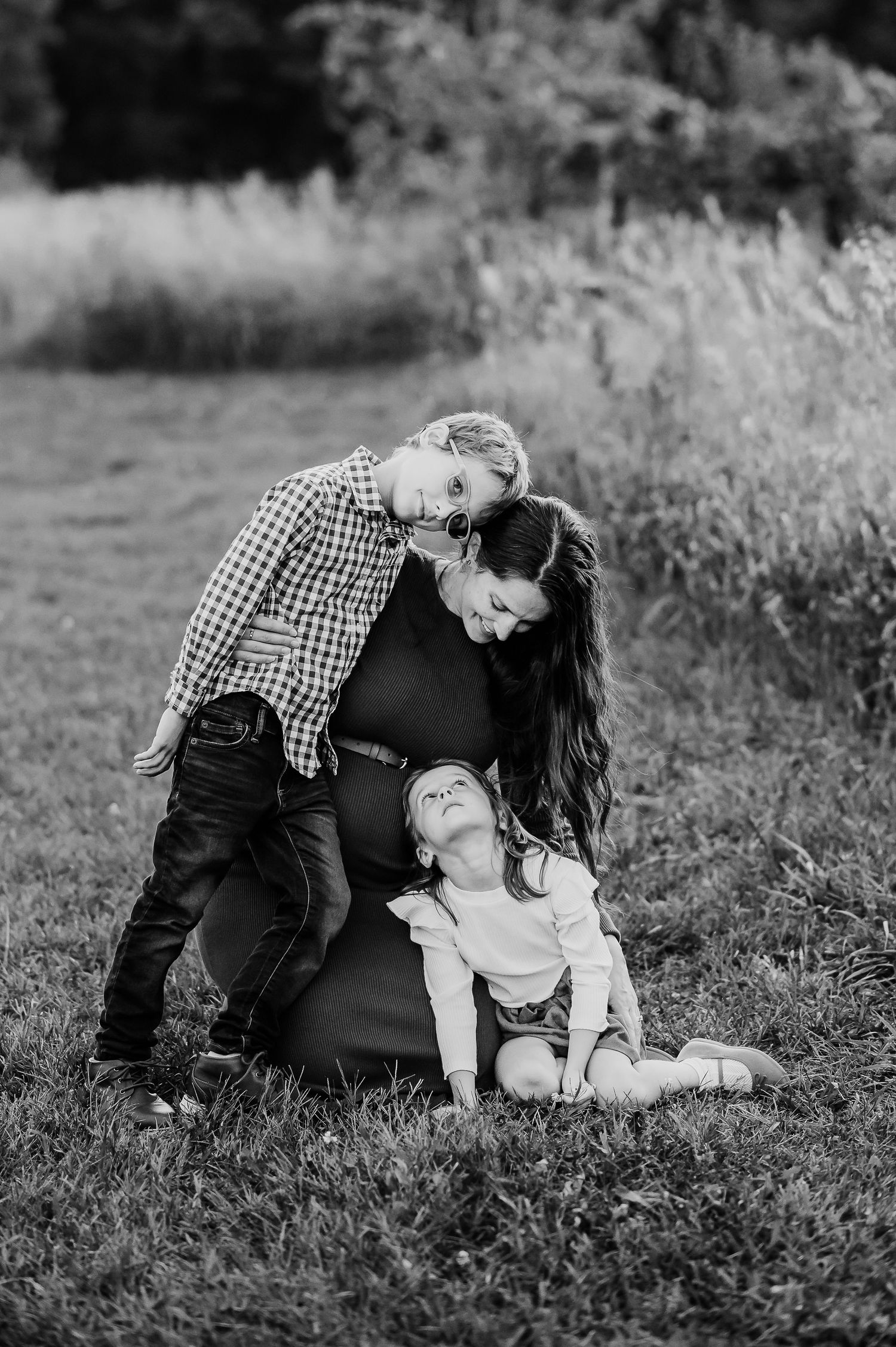 Black and white portrait capturing pregnant mom with children at Prophetstown State Park in West Lafayette, Indiana.