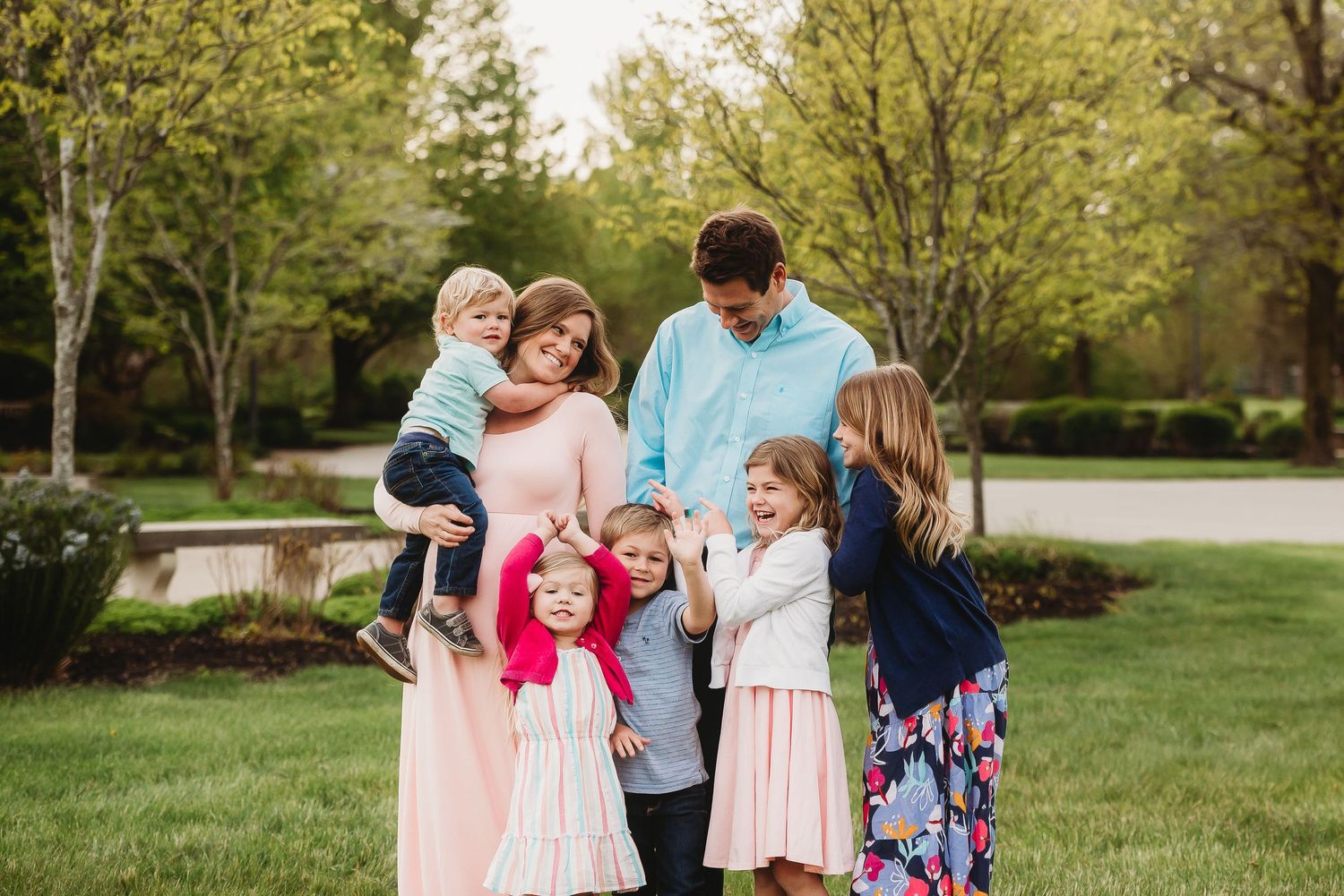 A family enjoys a sunny spring day together in a lush green park setting in Plainfield, Indiana.