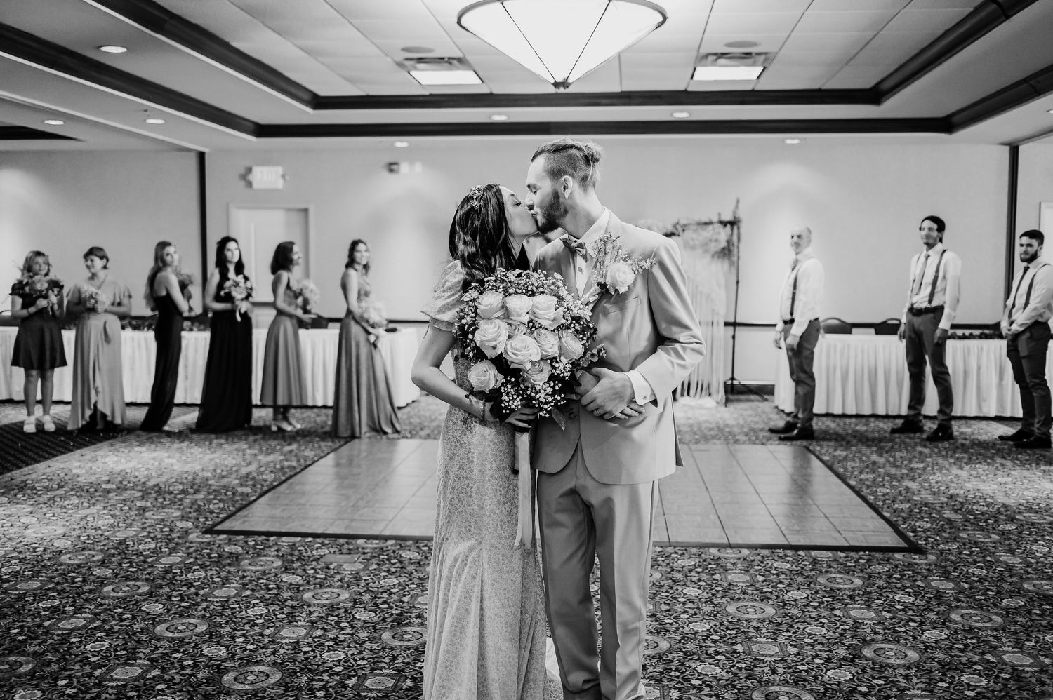 Wide angle view of a wedding reception venue with elegant lighting and decor.