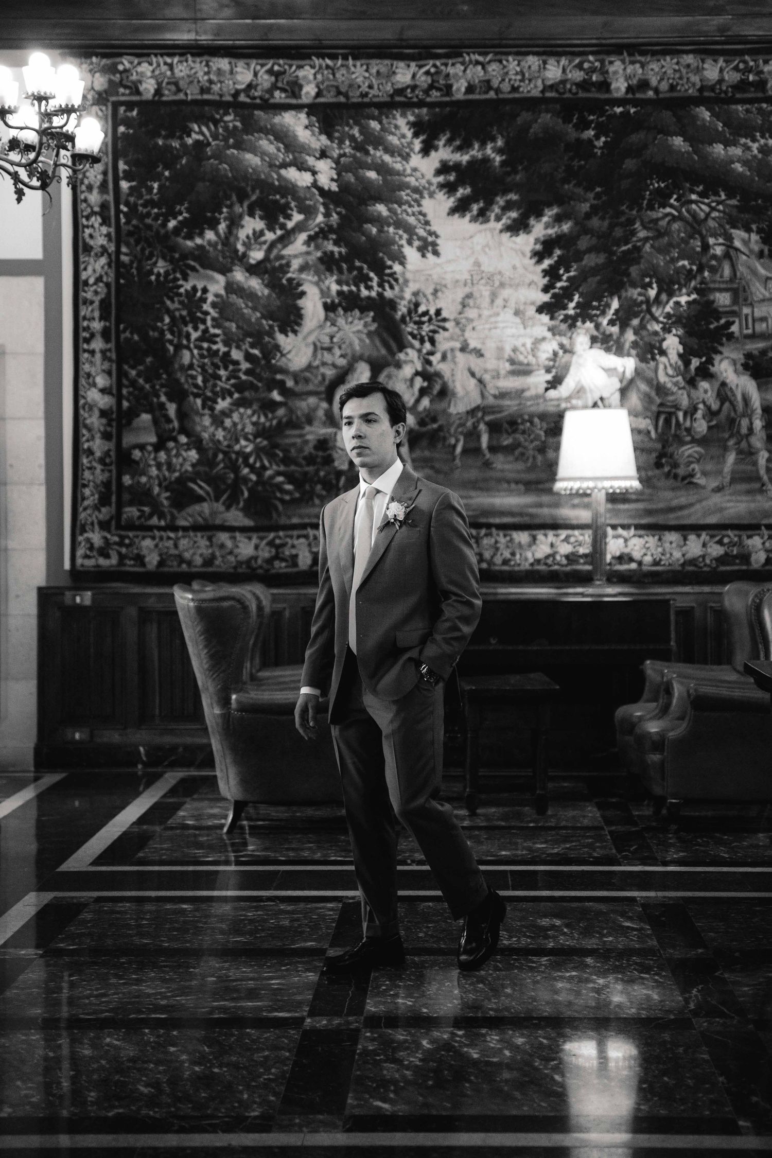 Black and white photo sequence showing a person performing dance movements in formal attire on a reflective floor.