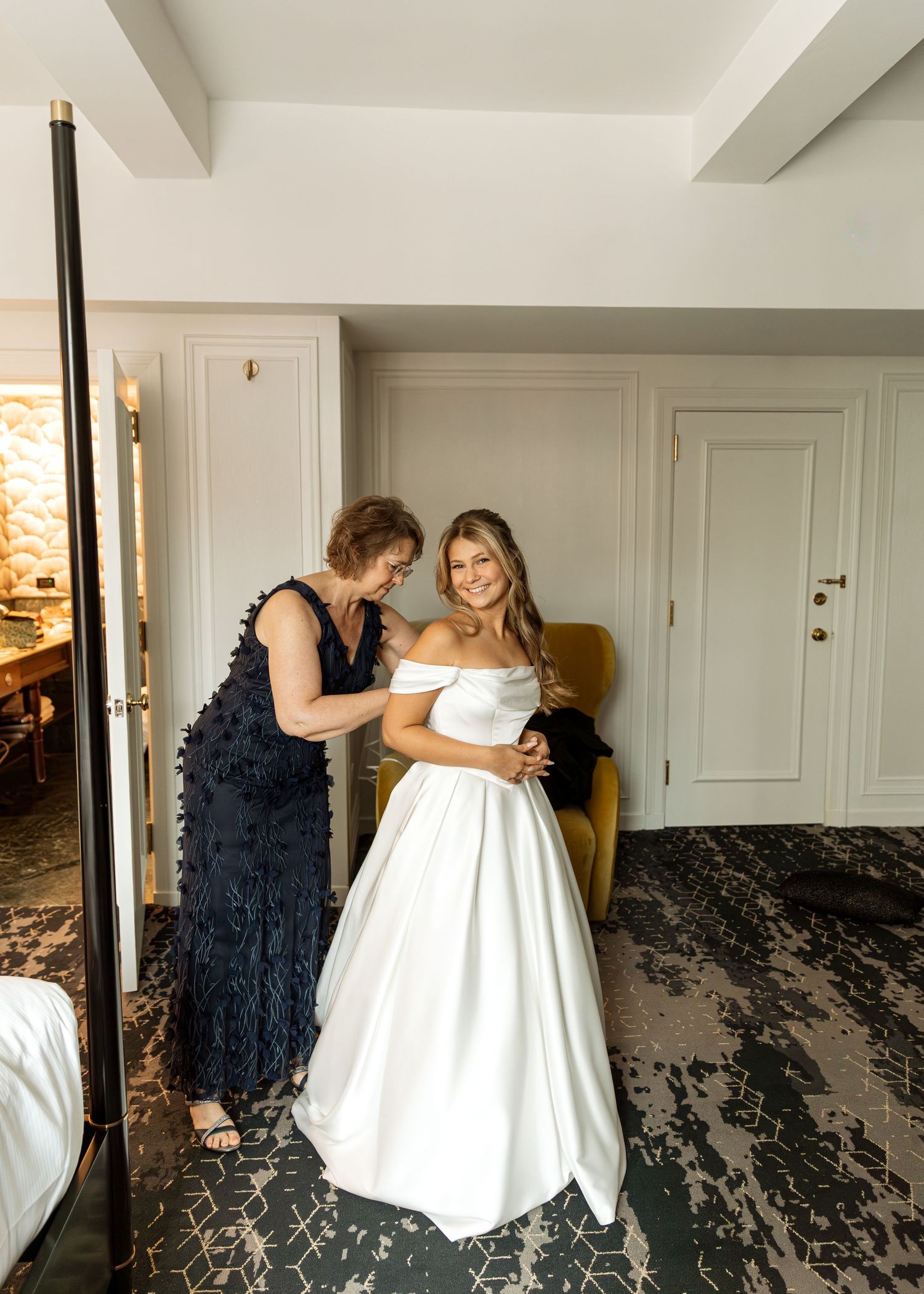 Wedding preparation scene in a bright room with formal attire.