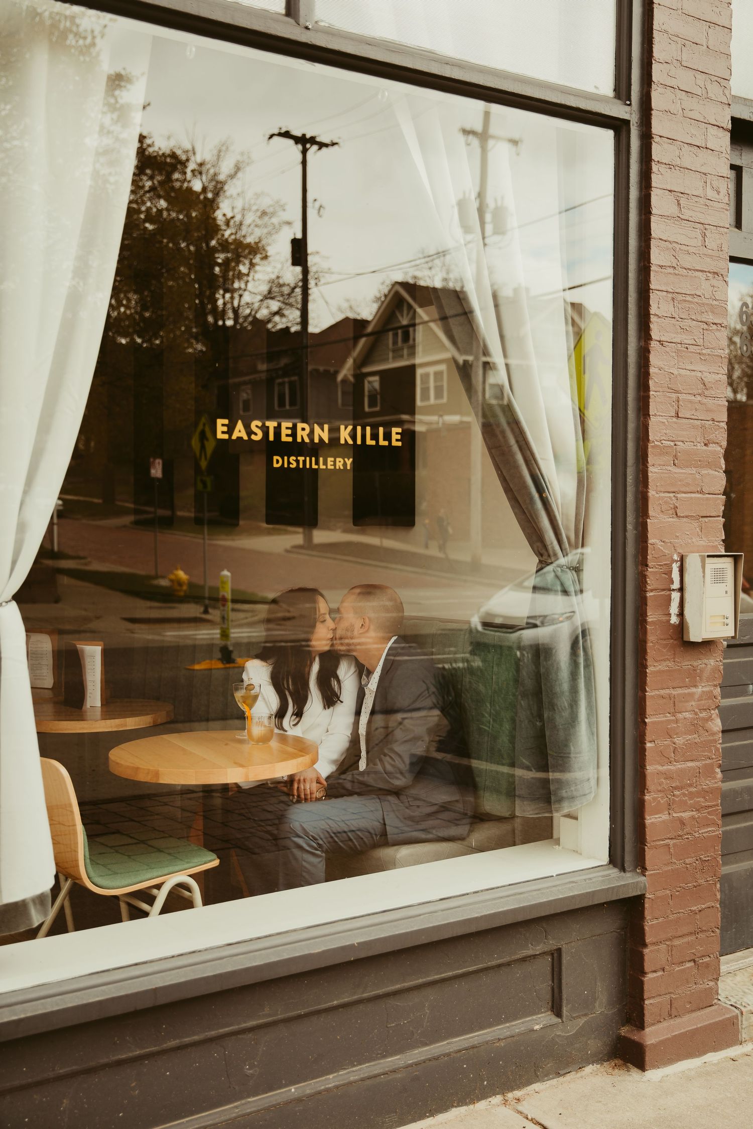 View through window of Eastern Kille Distillery showing interior seating area.