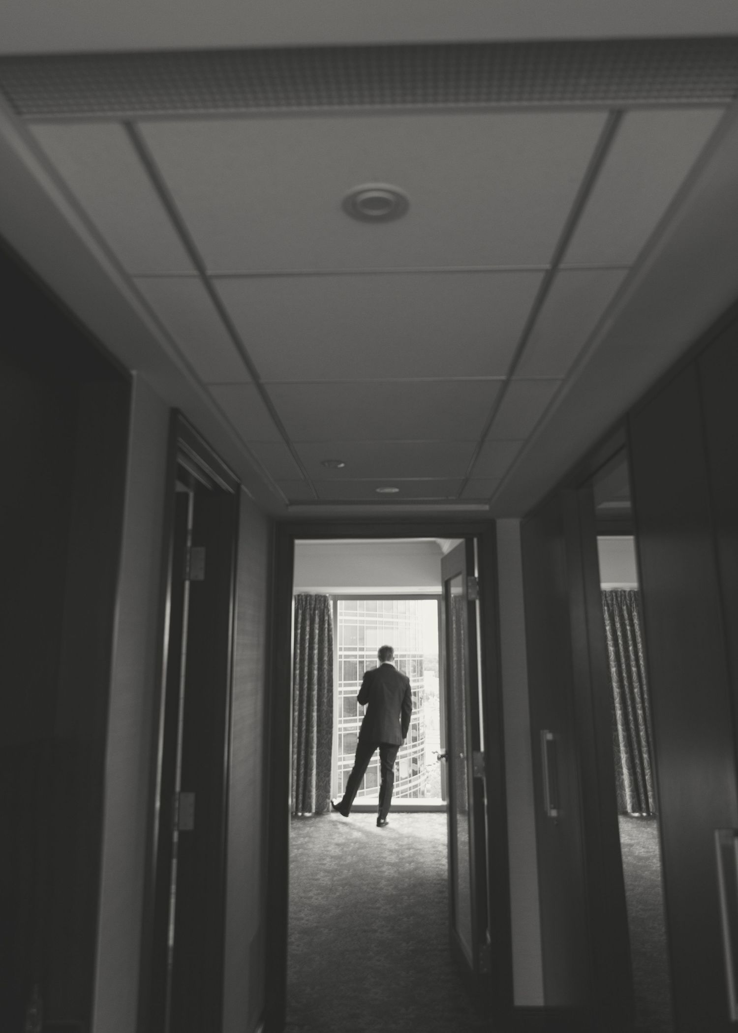 Dark hallway sequence showing a person walking away into the distance.