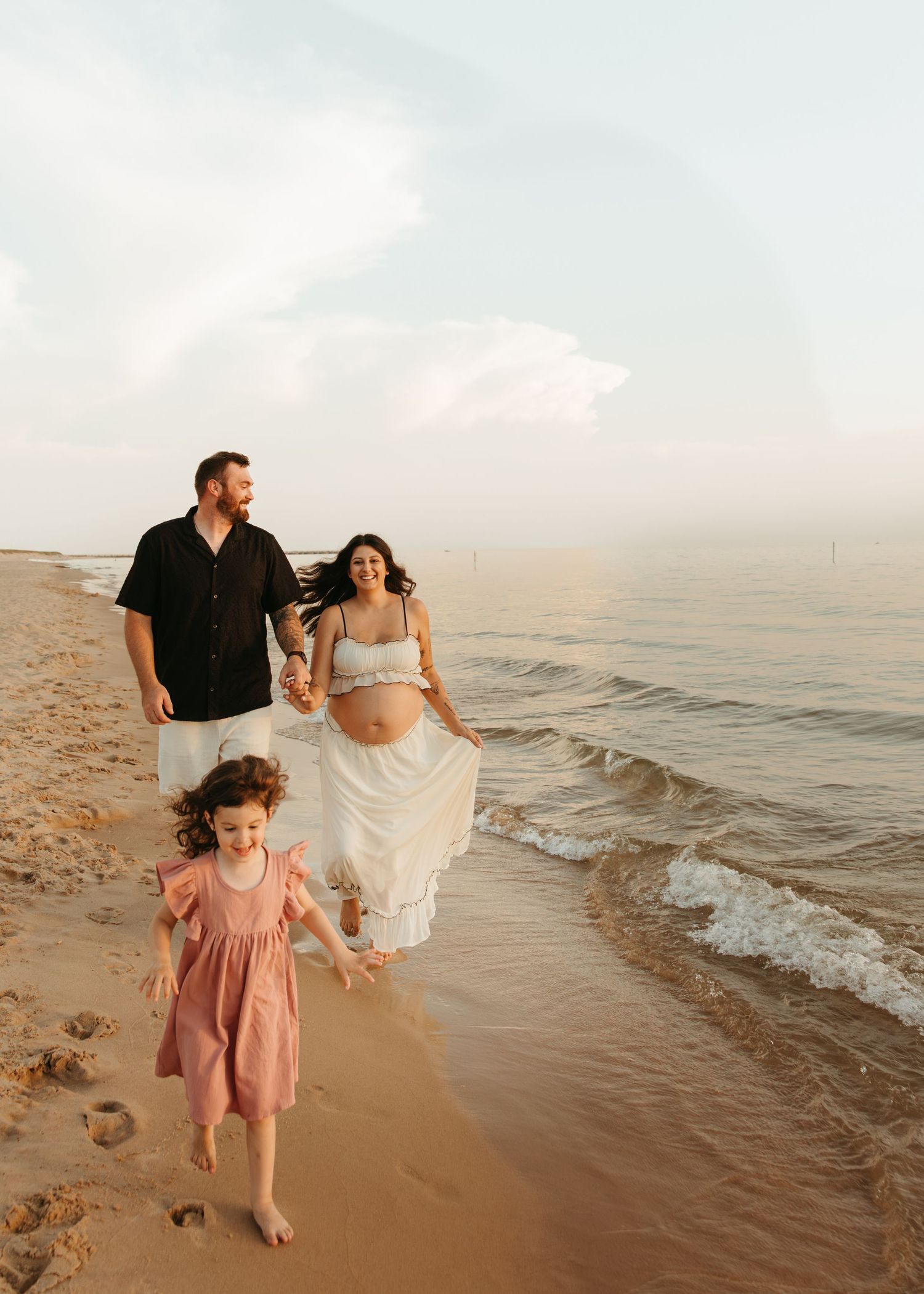 A joyful family moment captured while playing on a beach at sunset.
