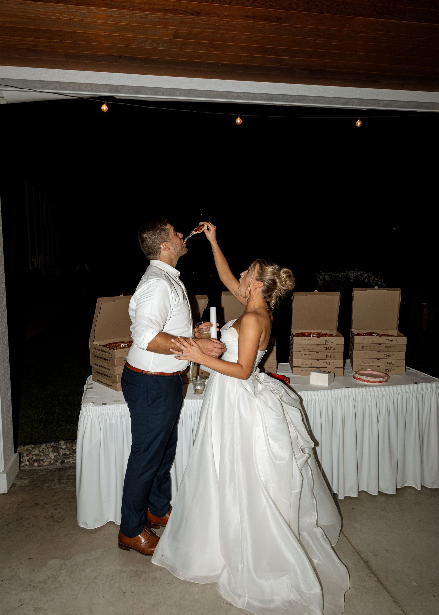 Wedding celebration dance moves captured against a backdrop of reception tables.