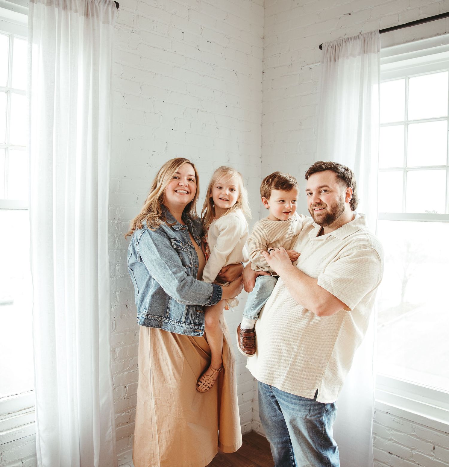 Family having fun and making silly faces in bright indoor space.